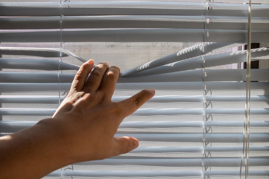 Professional contractor measuring for window blinds installation