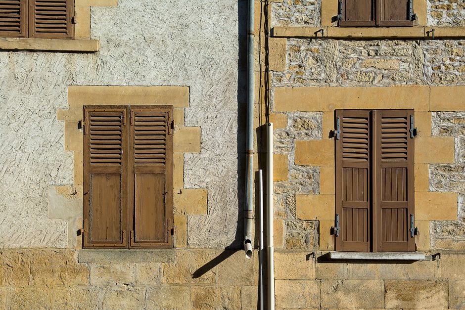 Classic white plantation shutters on large windows